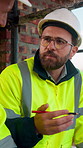 Construction site, architect and talking with team, man or project feedback for building development. Engineer, discussion or people with infrastructure, meeting or safety compliance for architecture