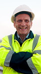 Face, engineer and smile with arms crossed outdoor for construction, inspection and maintenance. Portrait, mature man and helmet for leadership, building development and positive attitude for project