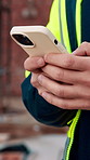 Construction, worker and hands on site with phone, text message notification and engineering update. Engineer, person and tech outdoor for typing email, project feedback and infrastructure research.