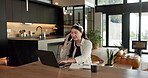 Asian woman, laptop and phone call in home, remote work and talk to client for advertising. Pc, mobile and freelance marketer in house, typing or happy with negotiation for social media sponsorship