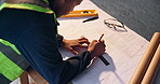 Hands, architect and writing with blueprint on construction site for building design or planning. Top view, male person or civil engineer with floor layout for architecture project or development
