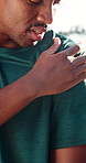 Athlete, hurt and man with shoulder pain, outdoor and massage for muscle sprain or injury in nature. Fitness, accident and black person with joint tension, runner and strain after physical activity