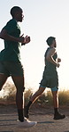 Athlete, people and running outdoor for fitness, exercise and endurance training for wellness. Below, men or friends on mountain trail for cardio, physical activity or morning jog for sports practice