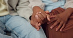 Couple, holding hands and loyalty in house, love and bonding with partner on weekend and connection. People, care and commitment for relationship, support and solidarity with spouse in apartment
