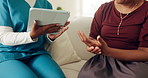 Caregiver, tablet and woman on sofa with hands, advice and medical consultation in senior care. Conversation, homecare and female person on couch with nurse, digital app and diagnosis discussion