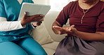 Nurse, tablet and woman on sofa with hands, advice and medical consultation in senior care. Conversation, homecare and female person on couch with caregiver, digital app and diagnosis discussion