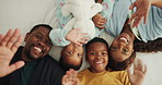 Wave, face and parents with children in bed for bonding, relationship and relax together. Family home, portrait and above of African kids with mom, dad and smile for trust, love and hello in bedroom