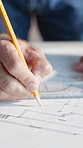Architecture, writing and hands of person with layout, design and blueprint for building project. Engineer, contractor and worker with pencil, scale and paper for floor plan, remodeling or renovation