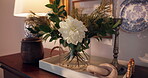 Vase, flower and living room in house with interior design, traditional ornaments or lamp for aesthetic. Glass container, peony plants and trinkets on furniture with art, decor and home accessories.