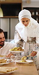 Muslim, family and dishing with food on dining table for islamic tradition or middle eastern cuisine. Mom, dad and child eating with meal or snacks for gathering, feast or culture together in home