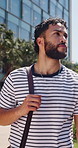 Thinking, man and student in city for travel, perspective and planning for university education. Thoughts, male person and walking outdoor for morning commute, reflection and daydreaming for learning