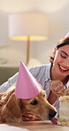 Lick, woman and dog in home with birthday cake, eating snack and happy for adoption milestone. Pet owner, hungry and stroke golden retriever in lounge for celebration, bonding and treat at party