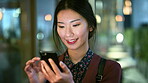 Asian woman, smile and phone in lobby for business, scroll or social media browse with agenda. Night, mobile app and person with tech in office for communication, networking and contact for schedule