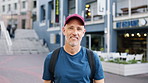Man, phone and face with travel in city with texting, check notification and chat with tourism on vacation. Mature person, happy and scroll with mobile app, contact or post on social media on holiday