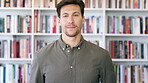 Professional, face and business man in library for publishing agency, author representative and creative. Literary agent, book editor and confidence with person in startup for pride and bookshelf