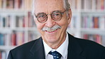 Smile, professor and face of man in library for about us, course lecturer and faculty manager. Education, university dean and bookshelf with mature person for pride, teacher and college advisor