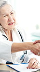 Handshake, greeting and doctor with woman in hospital for agreement in medical consultation. Appointment, welcome and healthcare worker shaking hands with patient for thank you at checkup in clinic.