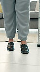 Legs, steps and person with walker in home for physiotherapy, recovery or rehabilitation. Mobility aid, equipment and woman with a disability in physical therapy session for development or exercise