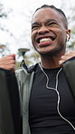 Fitness, man and excited with celebration at park for workout pace, performance or running goals. Earphones, black person and fist pump outdoor for cardio achievement, exercise target and improvement