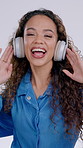 Face, dancing and woman in studio with headphones, audio and radio for streaming subscription. Movement, portrait and happy person with good mood, positivity and energy with music on white background
