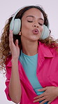 Dancing, singing and woman in studio with headphones, audio and radio for streaming subscription. White background, lyrics and person with good mood, movement and happy with music, playlist and song
