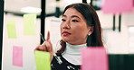 Woman, thinking and creative planning with sticky note in office on glass board for schedule tasks. Female person, employee or brainstorming with ideas, reminder or agenda for project in workplace