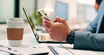 Hands, laptop and phone with business person at desk in workplace for report or update. App, computer and typing with employee man in coworking office for communication, planning or research