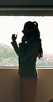 Businesswoman, talk and phone call in office with window, planning or instructions for finance audit. Profile, person and tech in firm with contact, financial job and discussion for risk management.