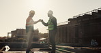 Construction site, men and fist bump with team, greeting and discussion for project development. Builder, collaboration and gesture outdoor for agreement, planning and architecture with sunshine