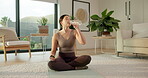 Yoga, relax and woman drinking water in home for holistic practice, exercise hydration and thirst. Yogi, asian person and beverage on break in living room for fitness nutrition, wellness and health