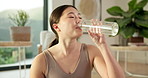Yoga, relax and woman drinking water in house for practice break, exercise hydration and thirsty. Health, asian person and rest with beverage in living room for fitness nutrition, wellness and detox