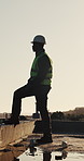 Engineer, man and walk at construction site with PPE, building inspection or thinking for renovation. Black person, contractor and civil engineering outdoor with infrastructure, project and planning.