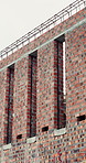 Brick wall, building and empty site for construction, foundation and exterior framework. Metal, concrete and masonry for structural support, urban development and civil engineering for architecture