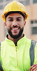 Man, engineer and face with arms crossed at construction site for smile, helmet and confidence. Person, technician or architect in portrait, happy or safety in city for property development in Mexico
