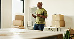 Moving, thinking and man with tablet in new home, interior decorating inspiration and box inventory. Smile, planning and black person with tech for online shopping, furniture order or renovation idea