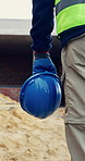 Walking, hands and person on construction site with helmet, infrastructure and property inspection. Architecture, civil engineering and worker for building safety, renovation and remodeling project