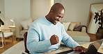 Home, business and black man with celebration, laptop and winner with email for loan approval. Person, victory and entrepreneur with pc, excited and positive review with proposal and profit growth