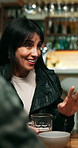 Pub, woman and talking with friends, beer and socializing with communication for connection at night. Bar, alcohol and mature person with conversation to share story, smile or gossip with bokeh