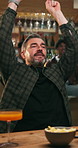 Celebration, fans and man with fist pump at pub, sports competition broadcast and excited for goal. Cheering, happy or mature person with friends for game live stream, tournament victory or high five