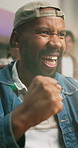 Fist pump, excited and man watching tv at pub, football tournament and applause for championship match. Game broadcast, celebrate and happy person with shout for winning team, clapping or soccer goal