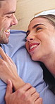 Couple, smile and romance in bedroom, talk and bonding with partner on weekend and together in home. Love, connection and affection for spouse, rest and happy people on break and laughing in house