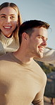 Happy, couple and playful on beach with piggyback, bonding together and energy for freedom on vacation. People, date and outdoor by ocean with fun relationship, holiday and wellness on tourist trip.