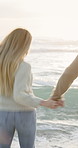 Couple, running and holding hands in ocean with holiday, bonding together and wellness on weekend. Happy, people dating and playful outdoor by beach with fun relationship, connection and vacation.