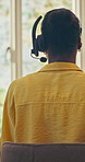 Home, headset and back of woman for remote work, virtual assistance and customer service. Talking, consultant and person at desk for communication, contact and online consulting for tech support