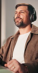 Creative, freelancer and man with headphones in home office, dancing and listening to music on break. Happy person, rhythm and streaming song with tech, remote work and audio subscription in house