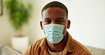 Face, man and mask for health in home, healthcare compliance or protection with wellness in lounge. Male person, portrait and facial guard for recovery, disease prevention and PPE for safety at house