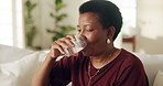 Water, pills and black woman in home for medical treatment, prescription and tablets for recovery. Healthcare, mature person and medication in living room for vitamins, supplements and drugs on sofa