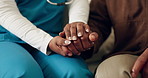Caregiver, holding hands and senior person with support, comfort and trust together in retirement home. Elderly care, medical help and nurse with empathy, solidarity and gratitude in living room