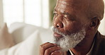 Black man, senior and thinking on couch at home, contemplating or daydreaming with wonder. Male person, retired and perspective, nostalgia or remember with memory, insight or reflection at house
