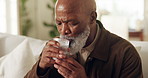Senior man, tremors and drinking water for hydration, health and symptoms of parkinsons disease. Elderly, black person with a disability and thirsty with beverage, diet and shaking disorder in home
